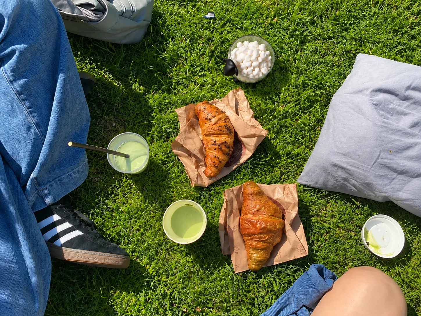 Picnic on the grass with croissants and the Sheeply sheep bowl filled with marshmallows
